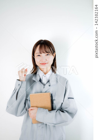 Female staff in work clothes during on-site work Female staff in work clothes during on-site work 142382164