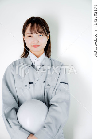 Female staff in work clothes during on-site work Female staff in work clothes during on-site work 142382179