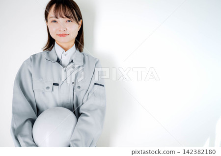 Female staff in work clothes during on-site work Female staff in work clothes during on-site work 142382180