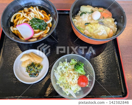 A set meal of udon noodles and Chinese rice bowl at a Japanese restaurant. A set meal of udon noodles and Chinese rice bowl at a Japanese restaurant. 142382846