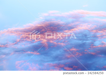 Beautiful sunset sky with pink and blue clouds at dusk Beautiful sunset sky with pink and blue clouds at dusk 142384250