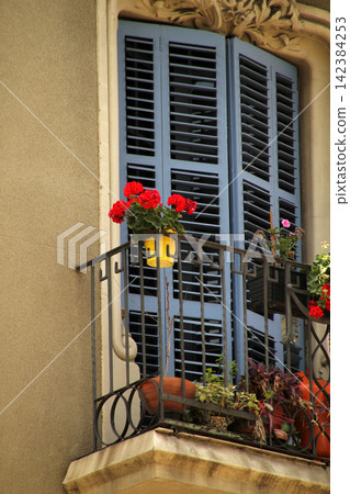 Balcony of a house with flowers 142384253