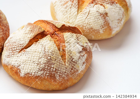 A photo of homemade country-style hard bread lined up. A photo of homemade country-style hard bread lined up. 142384934