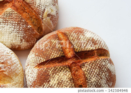 A photo of homemade country-style hard bread lined up. A photo of homemade country-style hard bread lined up. 142384946