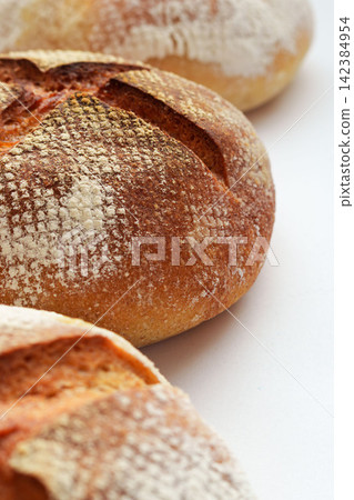 25 Homemade hard breads in the style of pain de campagne lined up for a photo shoot. 25 Homemade hard breads in the style of pain de campagne lined up for a photo shoot. 142384954