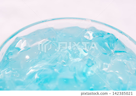 Studio photo shoot 22: Putting homemade light blue jelly texture into a glass. Studio photo shoot 22: Putting homemade light blue jelly texture into a glass. 142385021