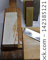 Whetstone and kitchen knife 142385121