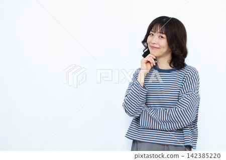 Woman thinking with a smile 142385220