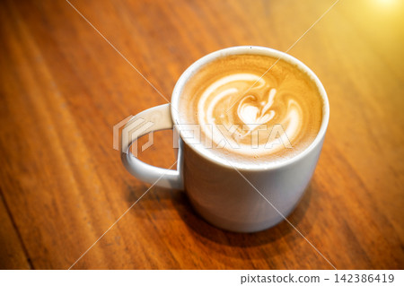 Hot latte coffee put on table in cafe restaurant, drink breakfast in the morning day. Hot latte coffee put on table in cafe restaurant, drink breakfast in the morning day. 142386419