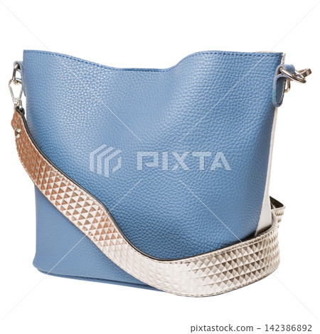 Blue leather womens handbag with patterned shoulder strap isolated on white background. Casual tote purse side view Blue leather womens handbag with patterned shoulder strap isolated on white background. Casual tote purse side view 142386892