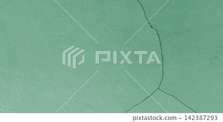 Cracked surface texture on a green painted wall. Cracked surface texture on a green painted wall. 142387293