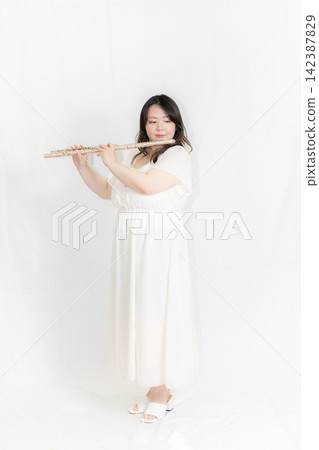 Woman with a flute Woman with a flute 142387829