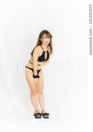 Girl in a bikini Girl in a bikini 142387925