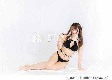 Girl in a bikini Girl in a bikini 142387928