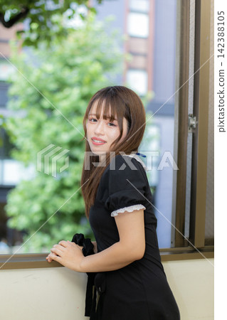 Summer outfit: Girl in a black dress at a resort. Summer outfit: Girl in a black dress at a resort. 142388105