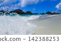 [Chichijima Island] The waves and blue sea at the secluded Ginny Beach, with raindrops and sunlight sparkling at the water's edge (16:9) 142388253
