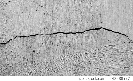 Horizontal cracks on a textured gray concrete surface. Horizontal cracks on a textured gray concrete surface. 142388557