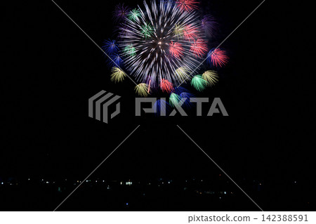 Colorful fireworks spread across the sea at Uozu Port. Colorful fireworks spread across the sea at Uozu Port. 142388591