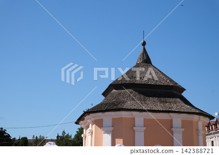 Historic Building with Distinctive Shingled Roof and Decorative Tower Architecture in Old Town Kamianets Podilskyi Ukraine Historic Building with Distinctive Shingled Roof and Decorative Tower Architecture in Old Town Kamianets Podilskyi Ukraine 142388721