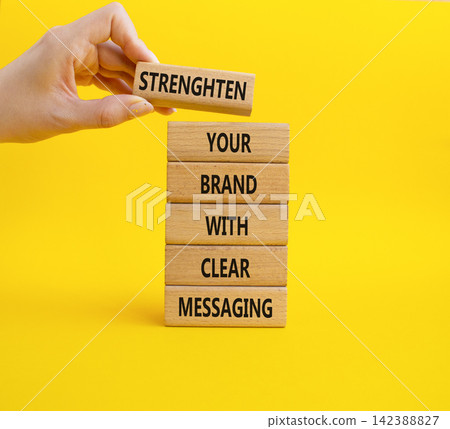 Strengthen your brand with clear messaging symbol. Concept words strengthen your brand with clear messaging on wooden blocks. Businessman hand. Beautiful yellow background. Business concept. Copy Strengthen your brand with clear messaging symbol. Concept words strengthen your brand with clear messaging on wooden blocks. Businessman hand. Beautiful yellow background. Business concept. Copy 142388827