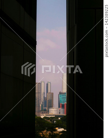 Low-angle view of modern glass skyscrapers and high-rise commercial office towers against the sky in the central business district of Jakarta, Indonesia. Low-angle view of modern glass skyscrapers and high-rise commercial office towers against the sky in the central business district of Jakarta, Indonesia. 142389225