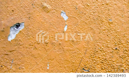 Peeling ocher yellow paint on a weathered wall texture Peeling ocher yellow paint on a weathered wall texture 142389493