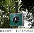 A road sign in nature that says "walk your bicycle." 142389688
