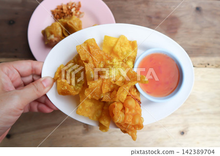 fried wonton, deep fried wonton or fried dumpling or deep fried dumpling and dip fried wonton, deep fried wonton or fried dumpling or deep fried dumpling and dip 142389704
