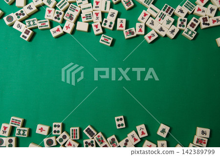 Mahjong tiles scattered on a mahjong mat (copy space available) 142389799
