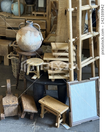 Wooden decor collection featuring stools, trays, and ladders, ideal for rustic backgrounds Wooden decor collection featuring stools, trays, and ladders, ideal for rustic backgrounds 142389942