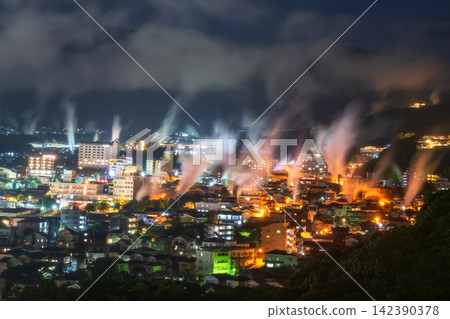 Beppu town with steam at night viewed from Yukemuri observatory Beppu town with steam at night viewed from Yukemuri observatory 142390378