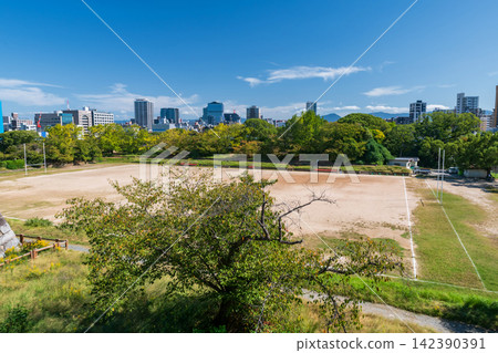Top view of rugby football field  against blue sky with Fukuoka city 142390391