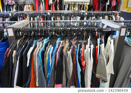 Second-hand clothing rack in thrift store 142390439