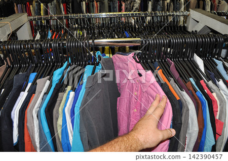 Second-hand shirts rack in thrift store Second-hand shirts rack in thrift store 142390457