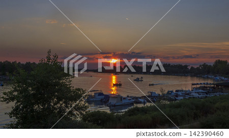 Sunset on Sava River in Sremska Mitrovica, Serbia, with boats 142390460