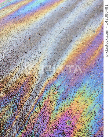 A leaked Car Oil Petrol in The Rain on a Tarmac Road Metallic Rainbow Gasoline A leaked Car Oil Petrol in The Rain on a Tarmac Road Metallic Rainbow Gasoline 142390491