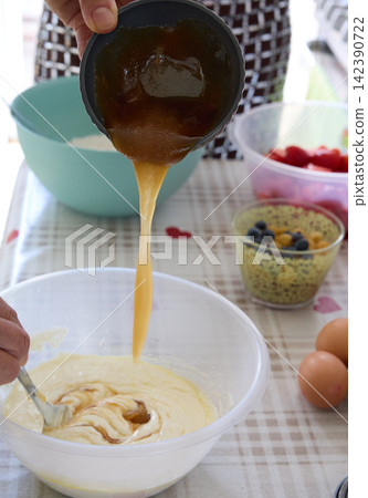 Pouring Honey Into Cake Batter During Homemade Baking Pouring Honey Into Cake Batter During Homemade Baking 142390722