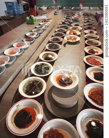 Assortment of authentic Indonesian Masakan Padang dishes served in small plates, traditional West Sumatran culinary spread Assortment of authentic Indonesian Masakan Padang dishes served in small plates, traditional West Sumatran culinary spread 142390891