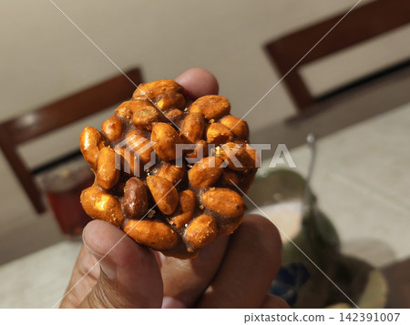 Traditional Indonesian Ampyang sweet snack made of roasted peanuts bound in hardened palm sugar and aromatic ginger Traditional Indonesian Ampyang sweet snack made of roasted peanuts bound in hardened palm sugar and aromatic ginger 142391007