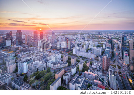 Towering Warsaw skyline at sunset with dramatic sky over Poland skyscrapers Towering Warsaw skyline at sunset with dramatic sky over Poland skyscrapers 142391198