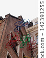 Colorful bicycle decorations adorn the wall. 142391255
