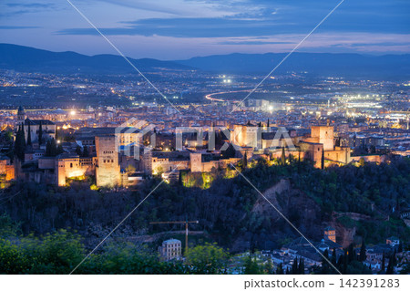 Illuminated Alhambra fortress and Granada cityscape at dusk Illuminated Alhambra fortress and Granada cityscape at dusk 142391283