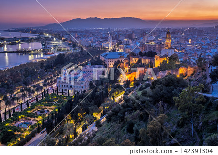 Twilight view of Malaga cityscape with Alcazaba and Cathedral Twilight view of Malaga cityscape with Alcazaba and Cathedral 142391304