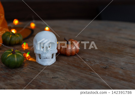 Halloween Still Life with White Skull Prop, Pumpkins, and Large Copy Space Halloween Still Life with White Skull Prop, Pumpkins, and Large Copy Space 142391786