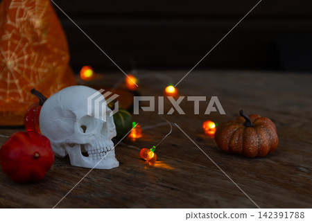 Halloween Veranda Decor: Cozy Skull Centerpiece with Pumpkins and Warm Lights 142391788