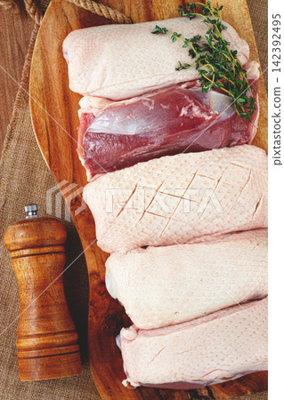 Fresh raw duck breast, on a wooden chopping board, top view, no people, Fresh raw duck breast, on a wooden chopping board, top view, no people, 142392495