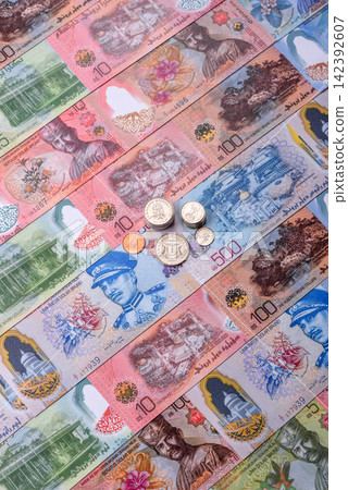 Brunei paper money, dollar banknotes and sen coins as currency for exchange or travel. Brunei money Brunei paper money, dollar banknotes and sen coins as currency for exchange or travel. Brunei money 142392607