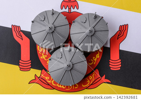 Liquefied gas storage tanks set against the Brunei flag, representing the concept of supply Liquefied gas storage tanks set against the Brunei flag, representing the concept of supply 142392681