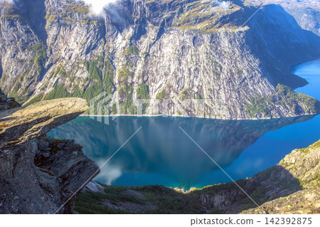 Exploring the stunning cliffs and blue waters in Norway's natural landscape Exploring the stunning cliffs and blue waters in Norway's natural landscape 142392875