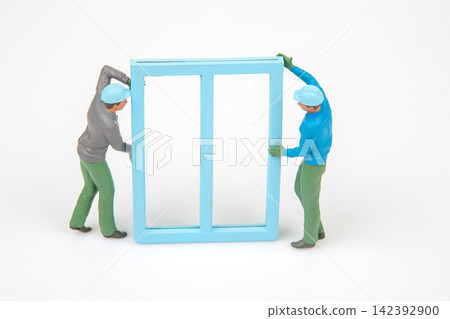 Miniature figures moving a blue door in a simple indoor setting Miniature figures moving a blue door in a simple indoor setting 142392900